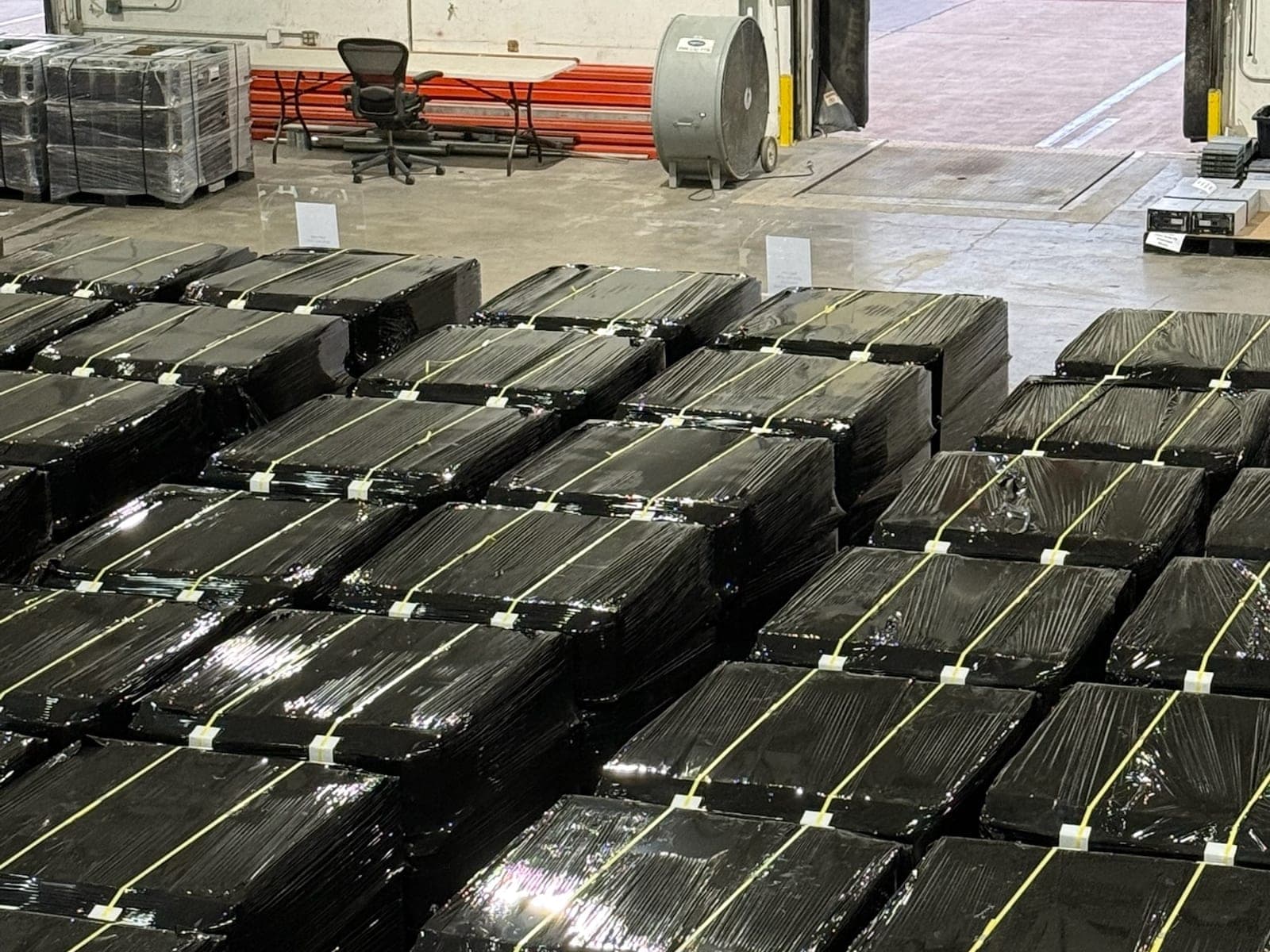 Wrapped and banded pallets staged for outbound freight at the ACS facility